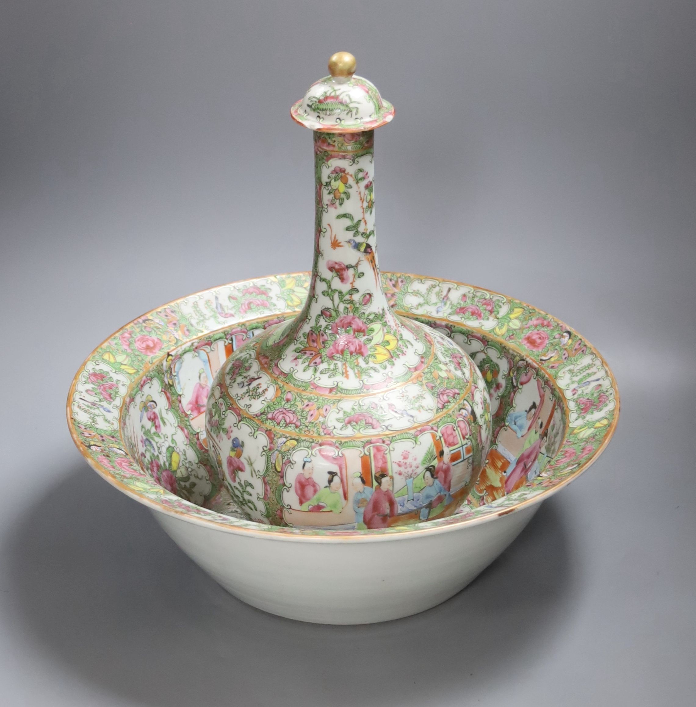 A 19th century Chinese famille rose water bottle with cover and basin, water bottle and cover 39 cms high.